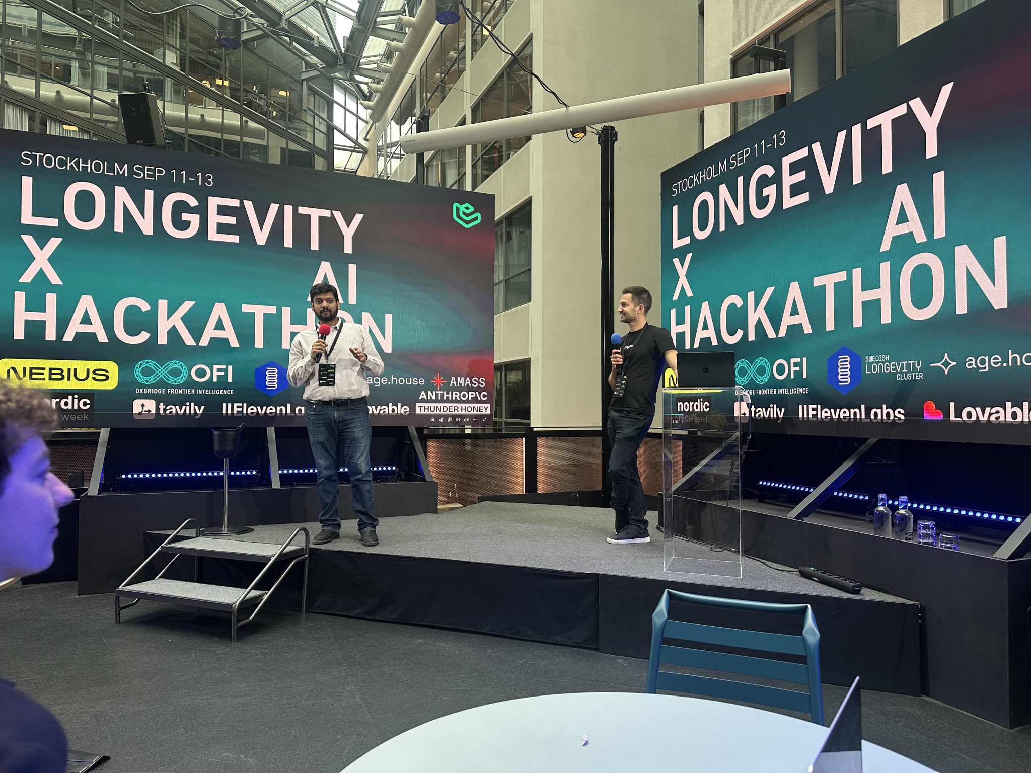 The hosts open the hackathon, with the partner logos on screen.